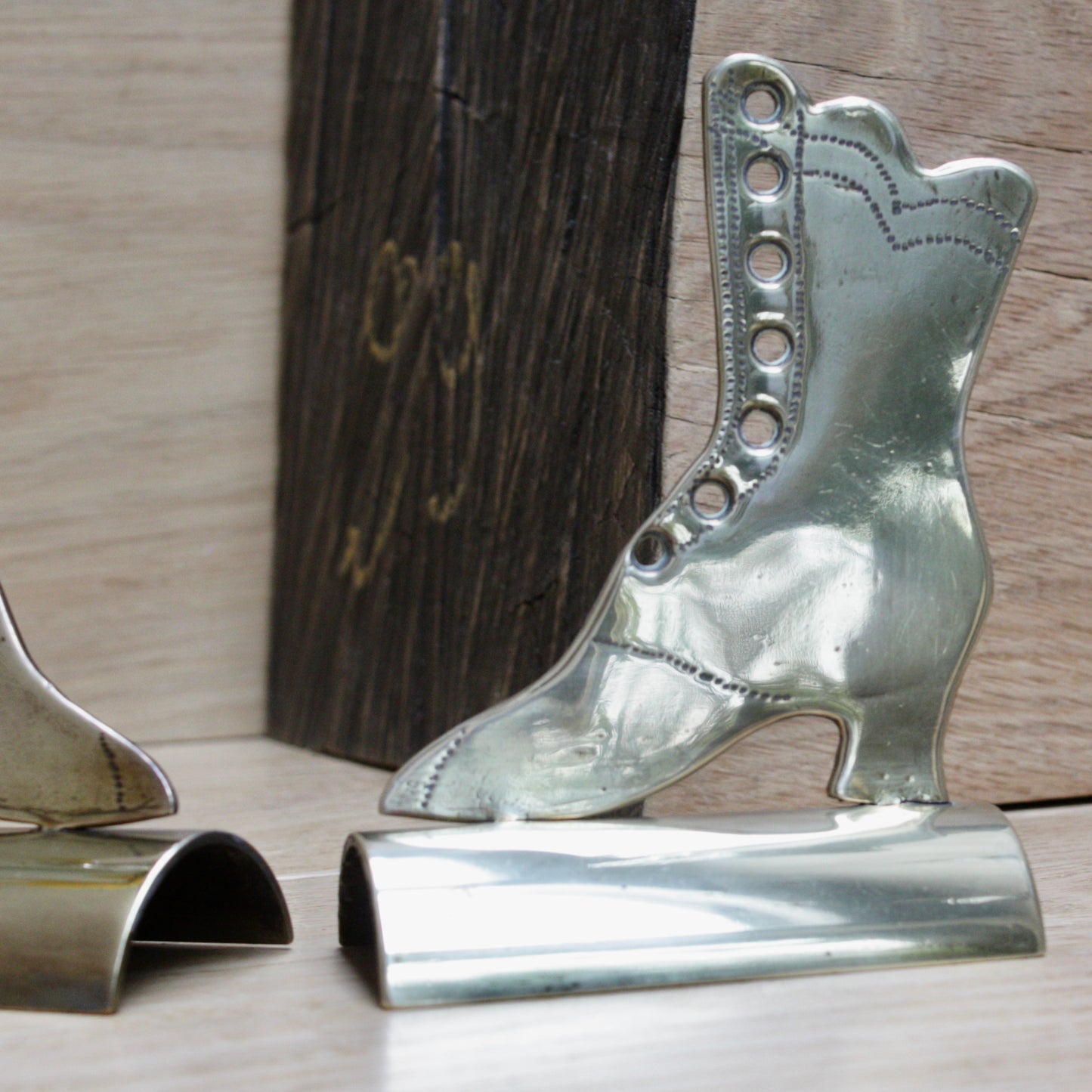 
                  
                    a pair of antique folk art mantlepiece brass boots
                  
                