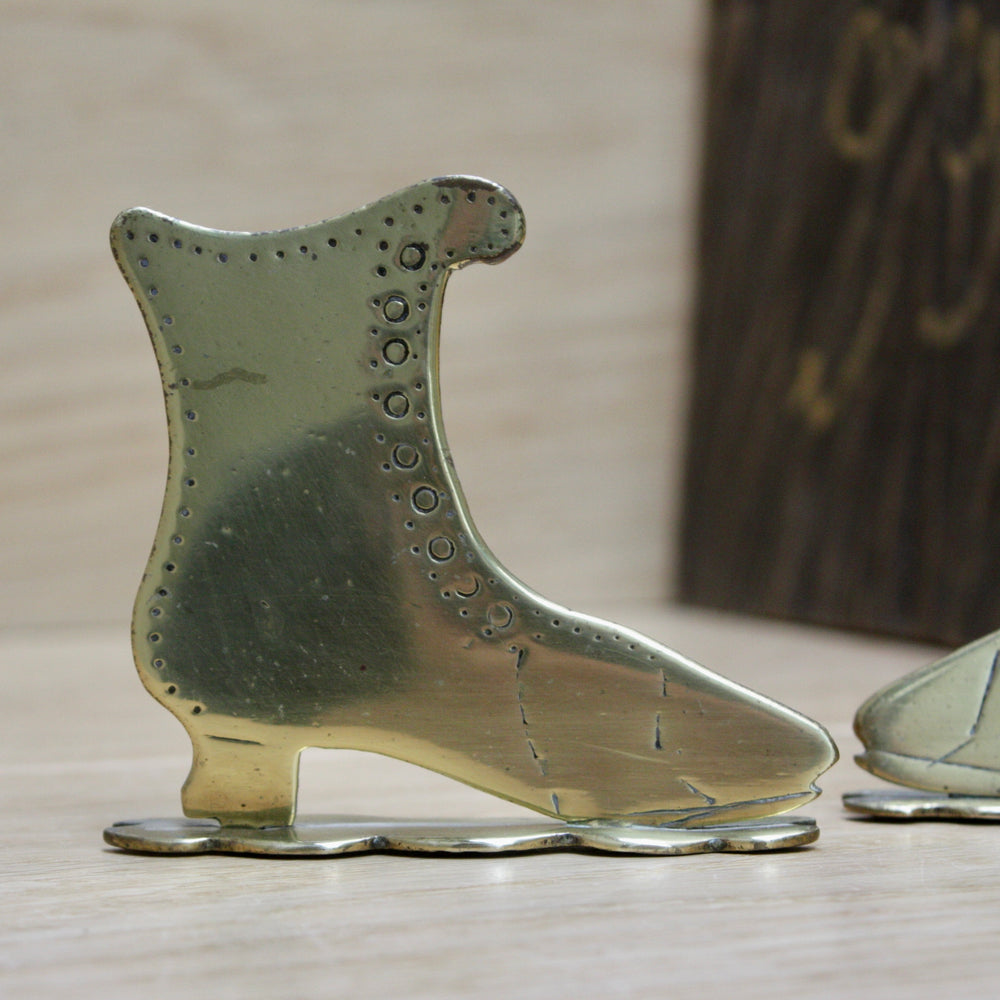 
                  
                    a small pair of antique folk art mantlepiece brass boots
                  
                