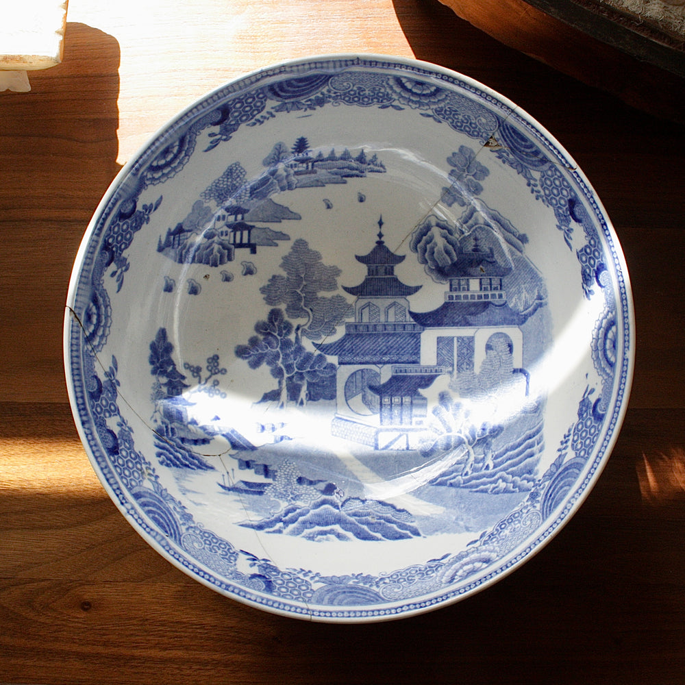 
                  
                    an antique willow pattern transfer ware tea service bowl
                  
                