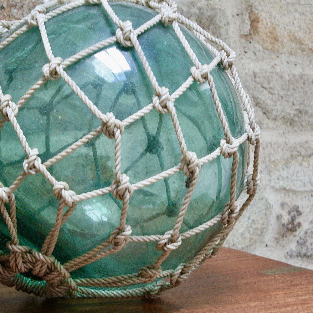
                  
                    a large vintage glass fishing float.
                  
                