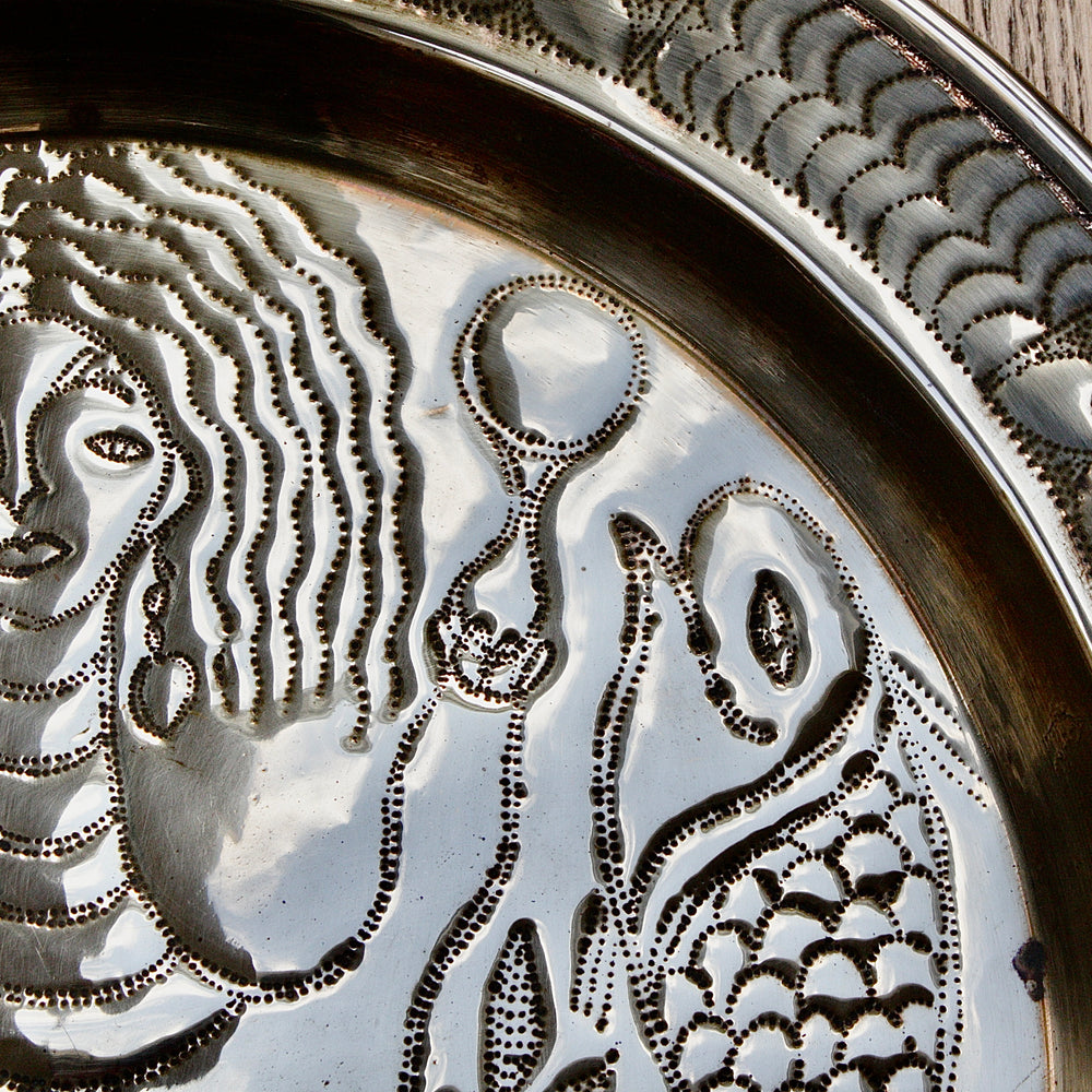 
                  
                    an african efic charger depicting mami wata.
                  
                