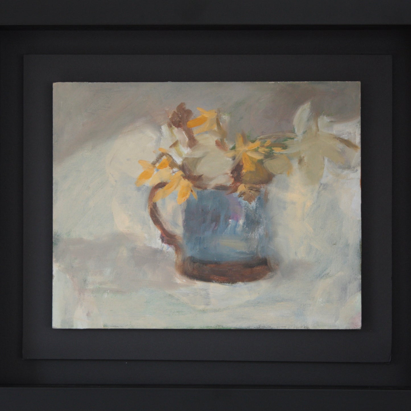 
                  
                    a blue mug and daffodils
                  
                