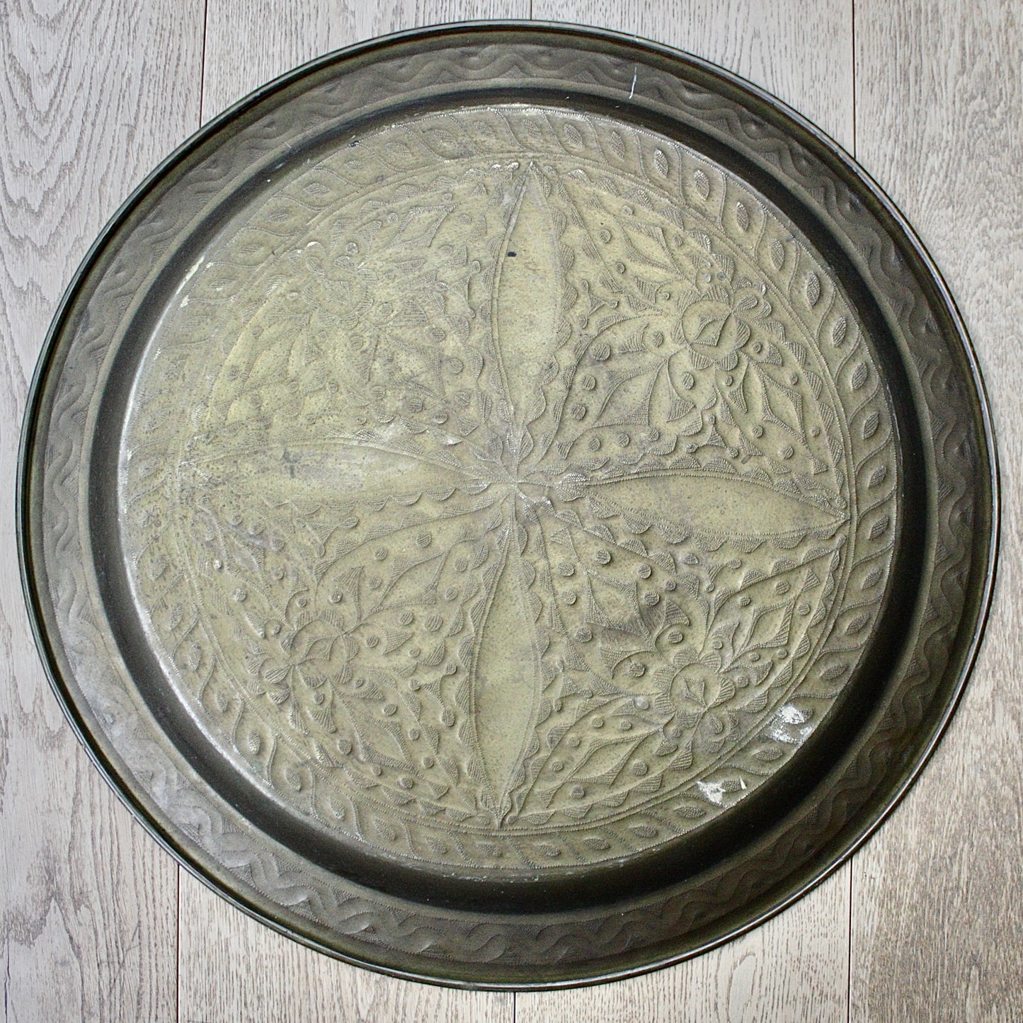 
                  
                    a 710mm diameter antique brass embossed charger from old calabar
                  
                