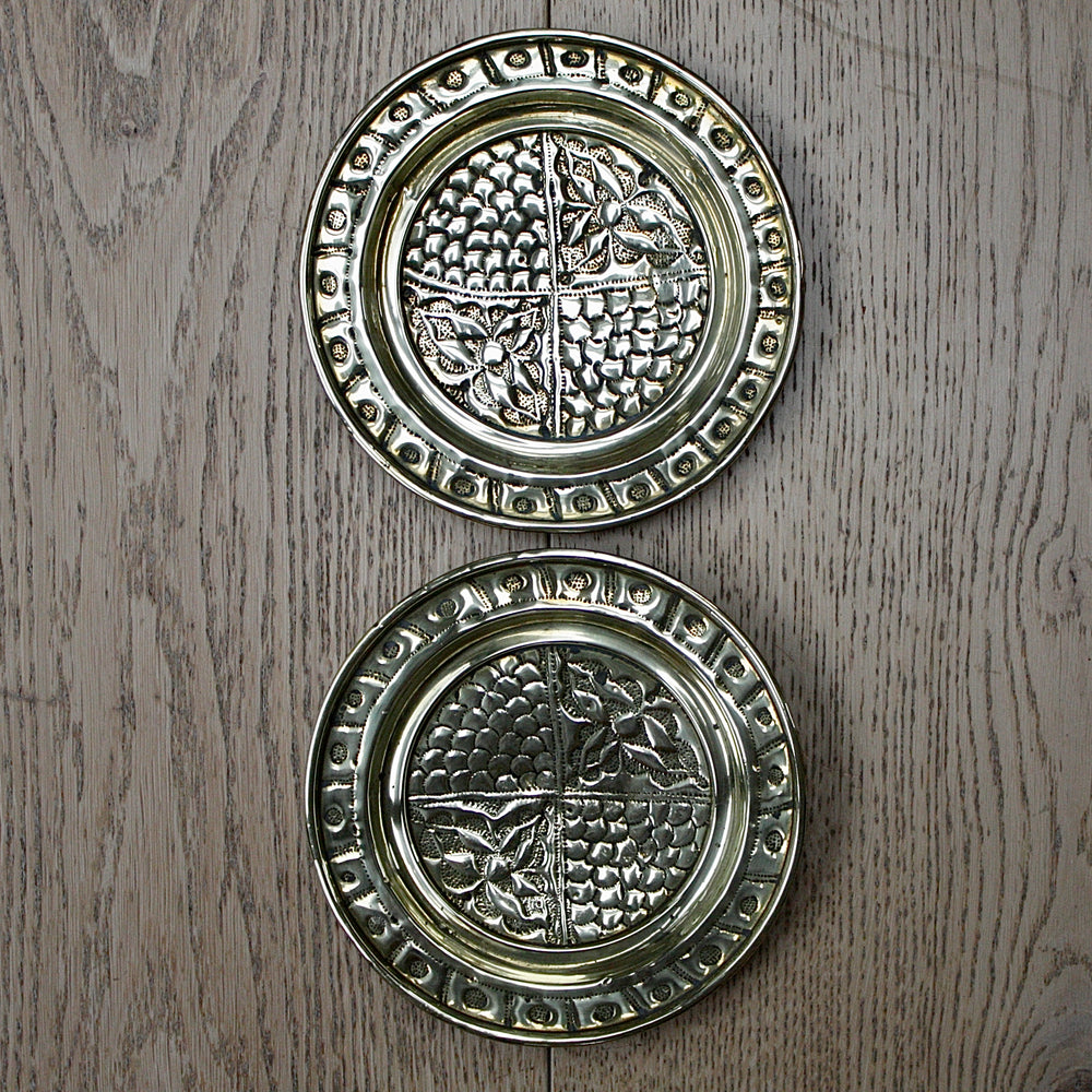 a pair of small embossed brass dishes from old calabar.
