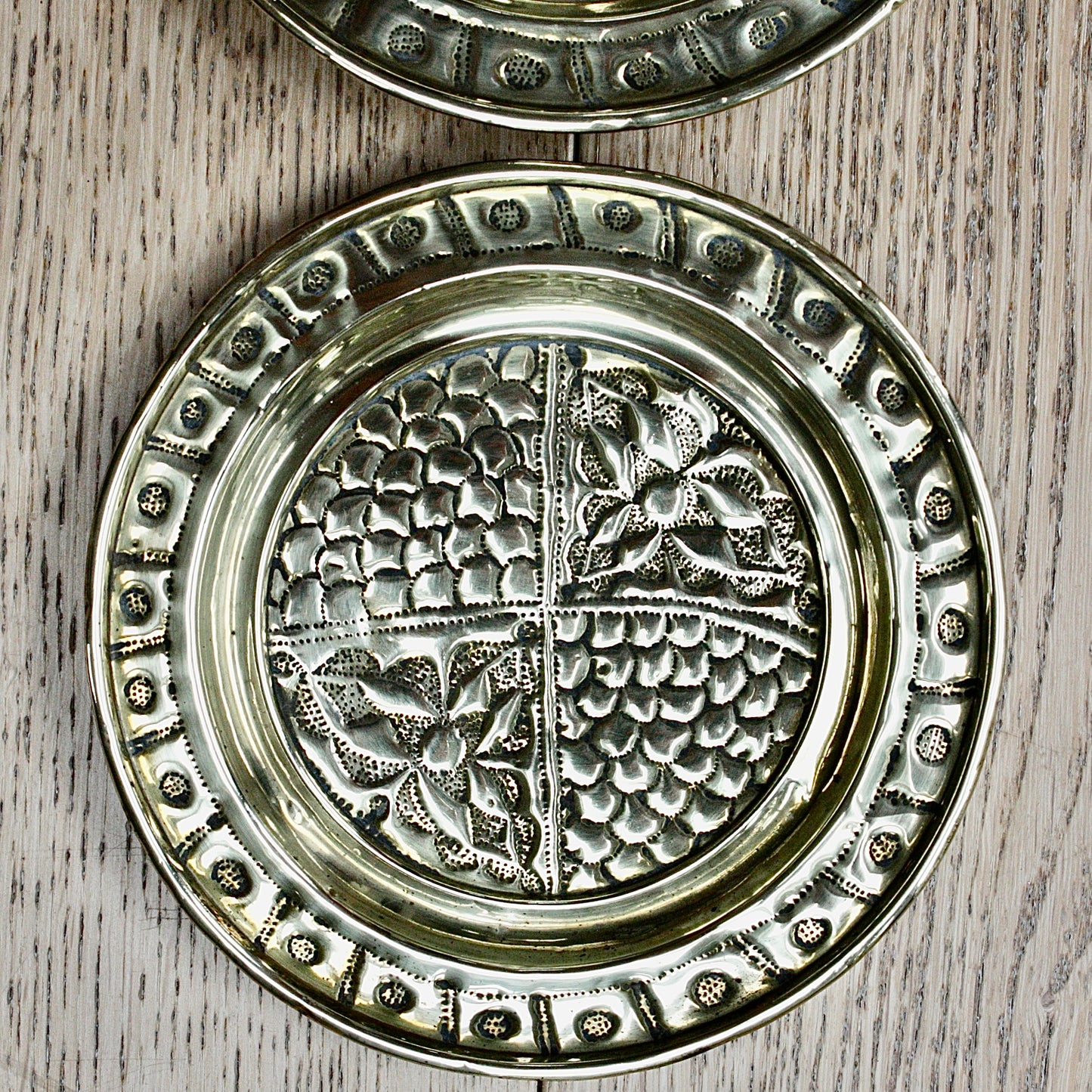 
                  
                    a pair of small embossed brass dishes from old calabar.
                  
                