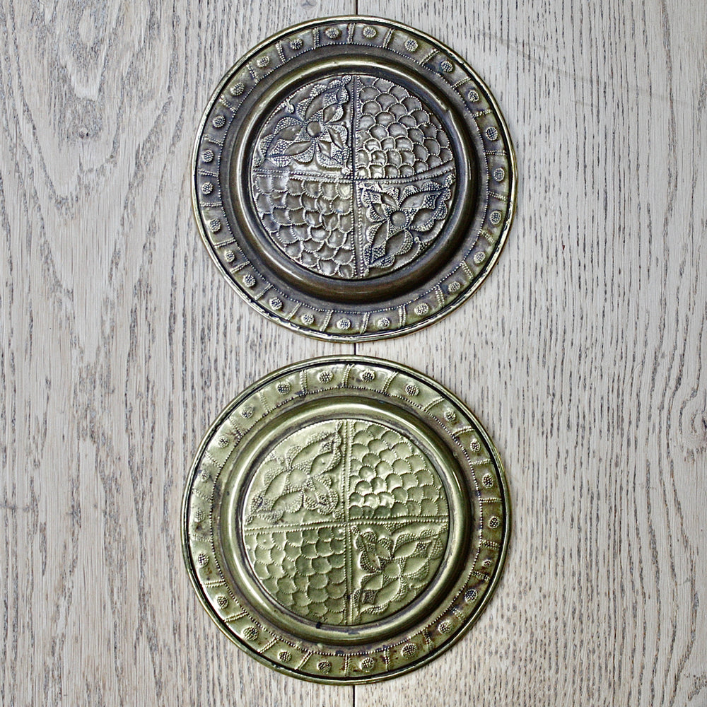 
                  
                    a pair of small embossed brass dishes from old calabar.
                  
                