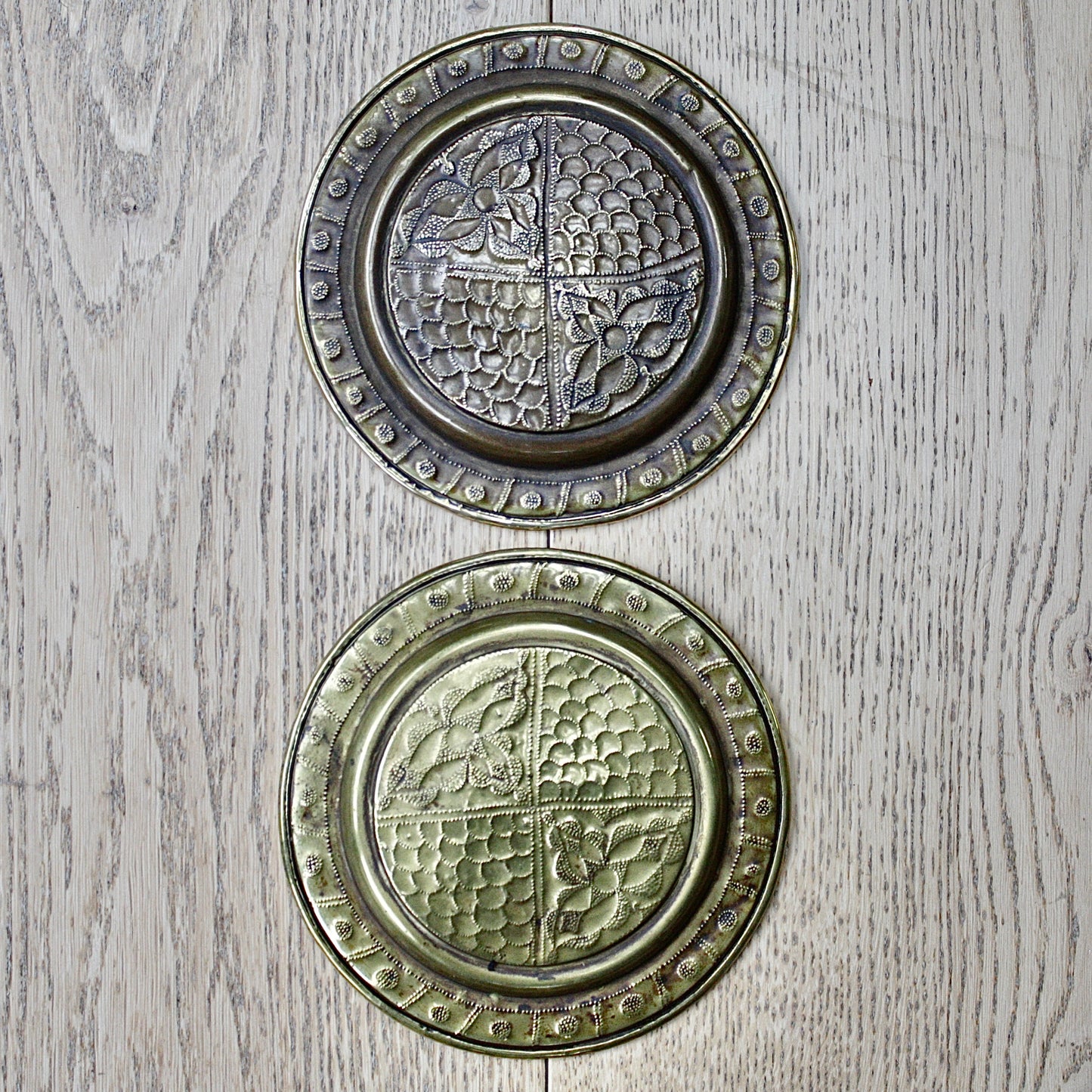 
                  
                    a pair of small embossed brass dishes from old calabar.
                  
                
