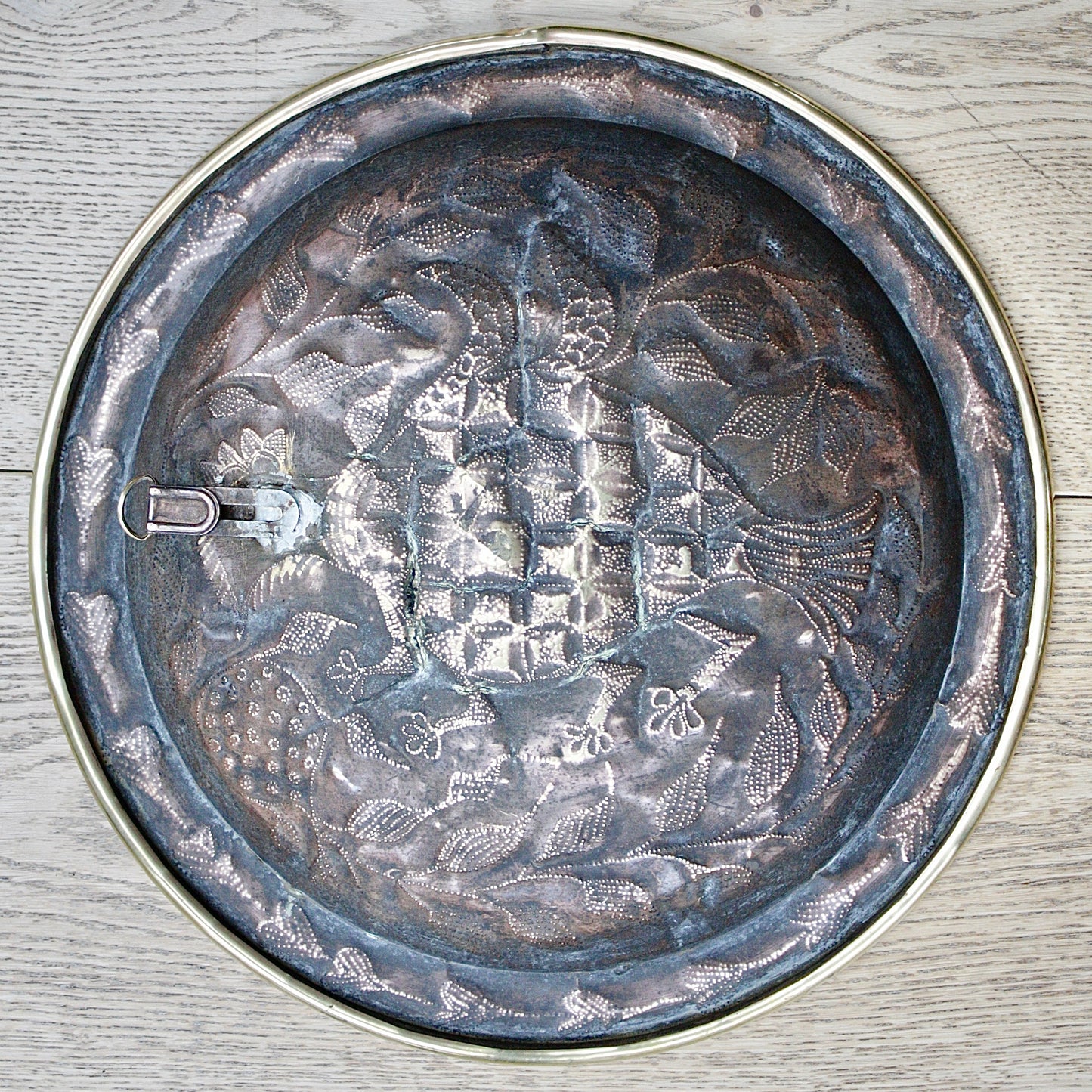 
                  
                    an embossed brass dish depicting " all of you " from old calabar.
                  
                