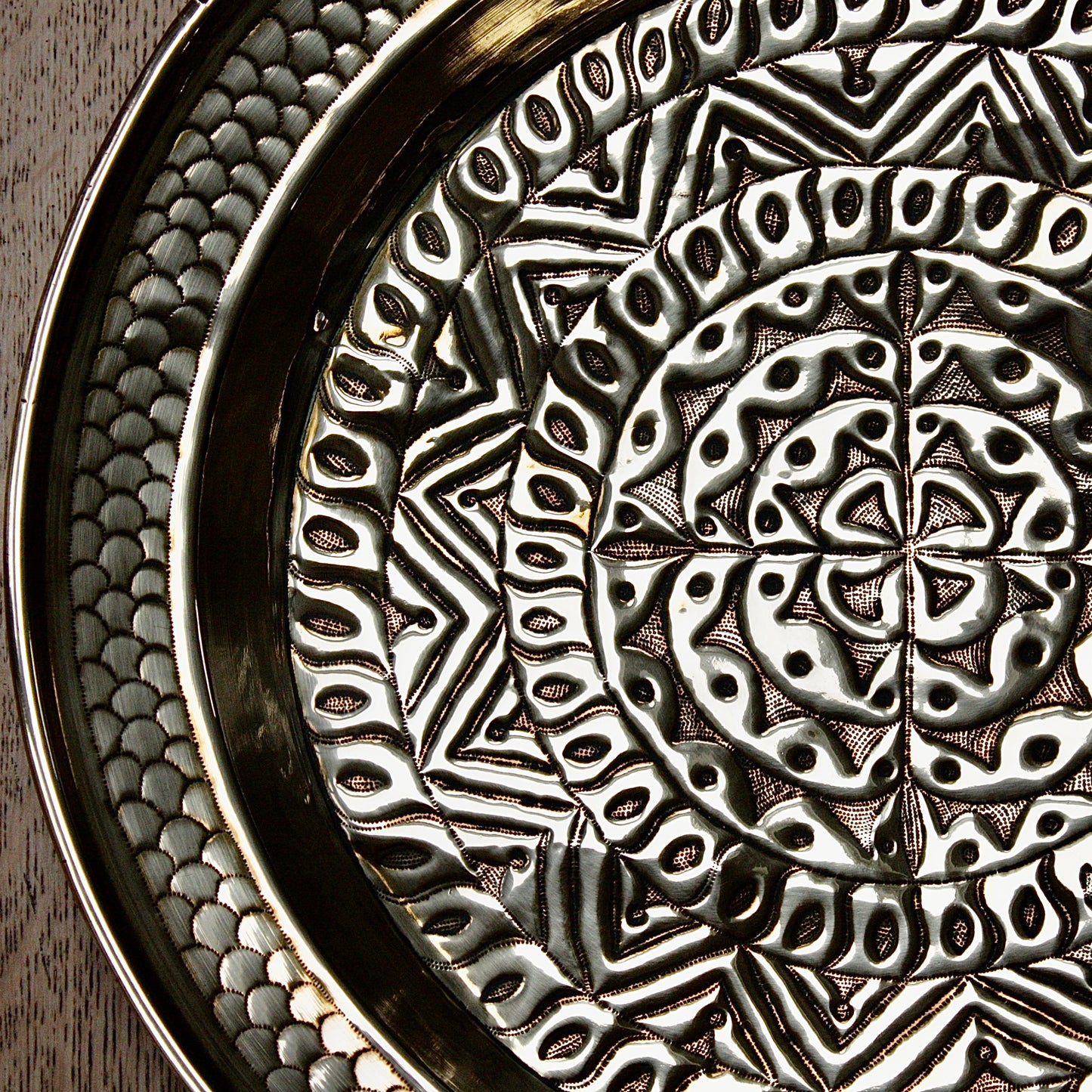 
                  
                    an embossed brass charger from old calabar  with geometric designs.
                  
                