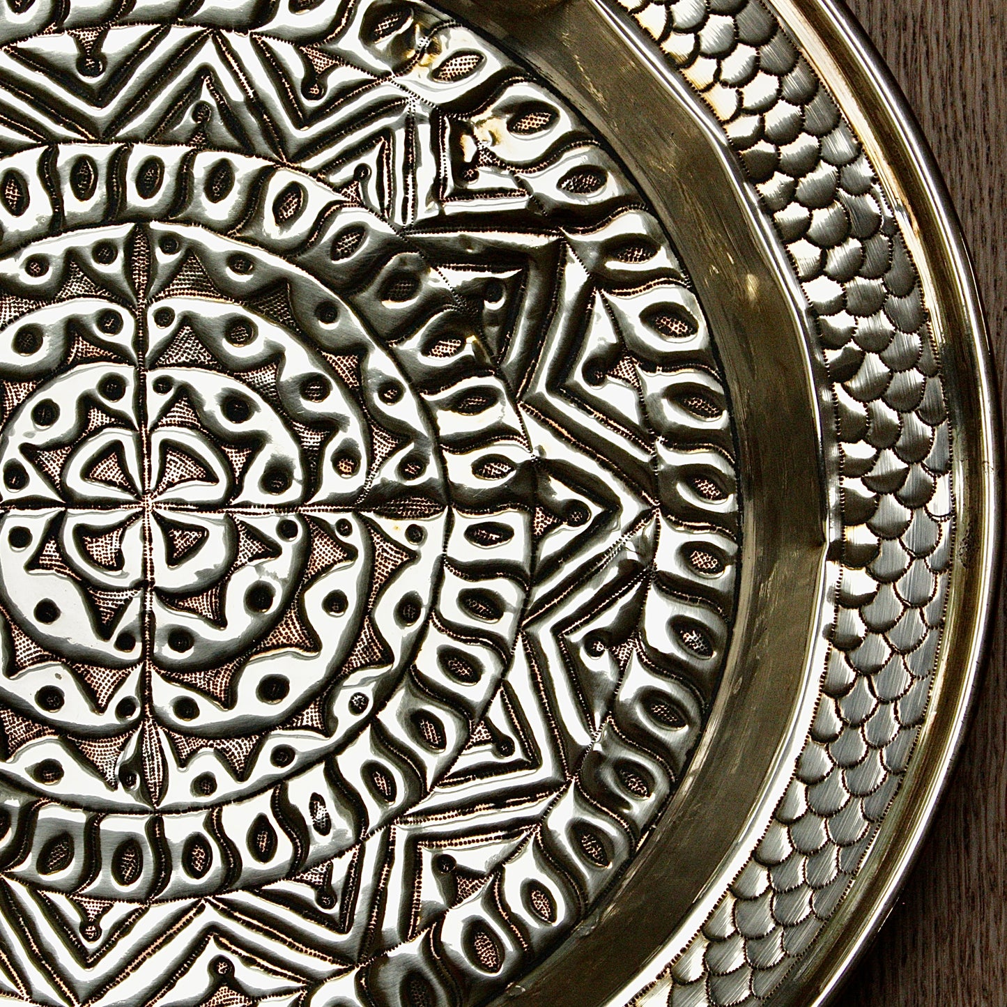 
                  
                    an embossed brass charger from old calabar  with geometric designs.
                  
                