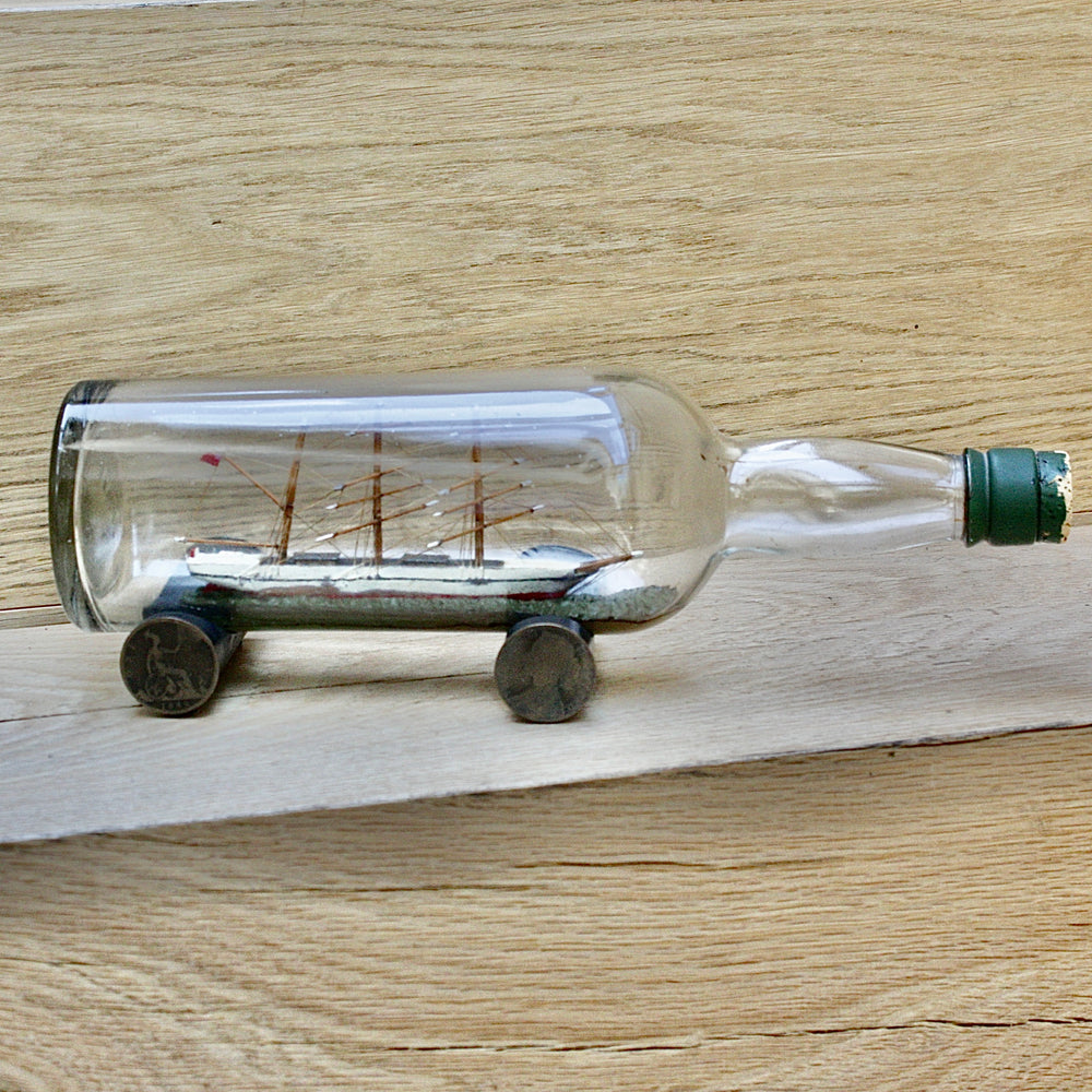 An early 20th century ship in a bottle.