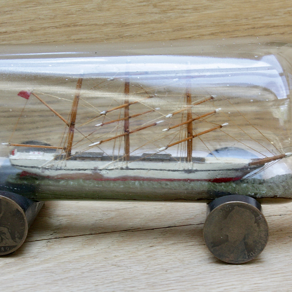 
                  
                    An early 20th century ship in a bottle.
                  
                