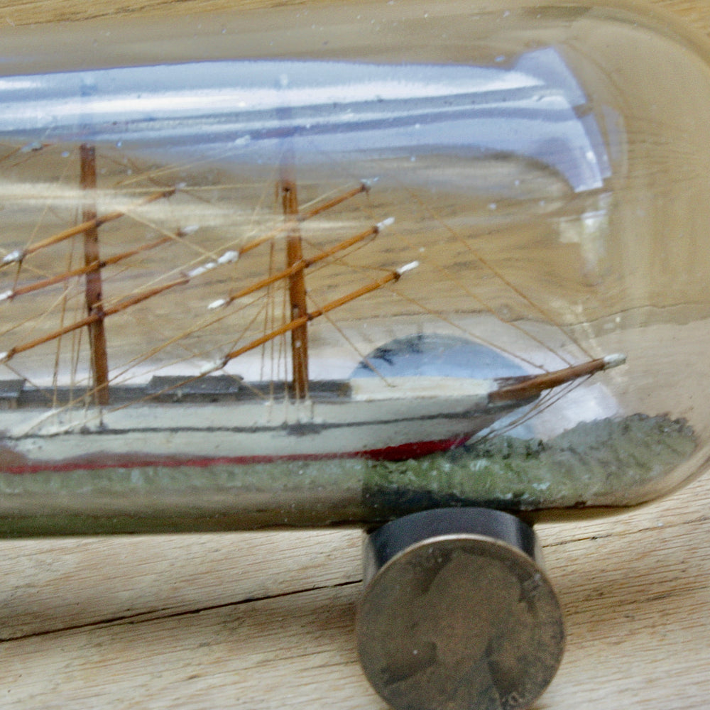 
                  
                    An early 20th century ship in a bottle.
                  
                