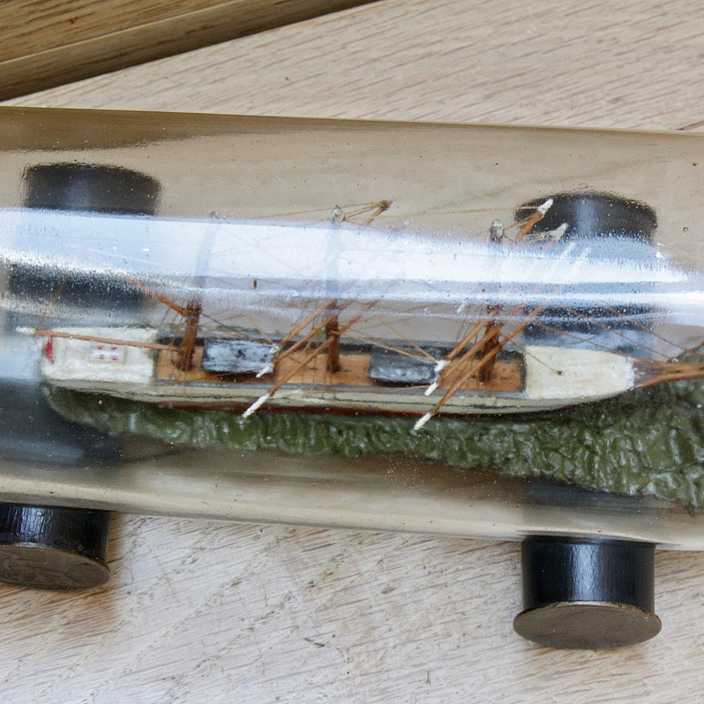 
                  
                    An early 20th century ship in a bottle.
                  
                