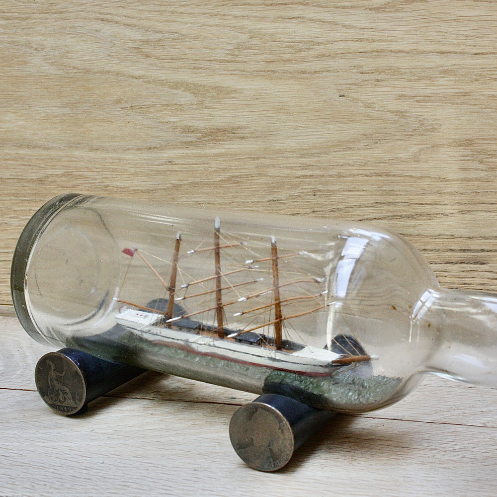 
                  
                    An early 20th century ship in a bottle.
                  
                