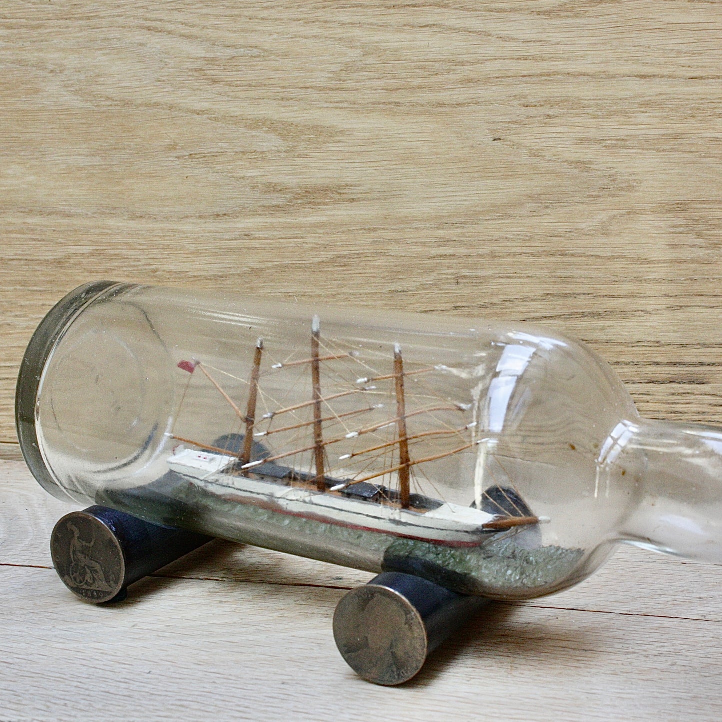 
                  
                    An early 20th century ship in a bottle.
                  
                