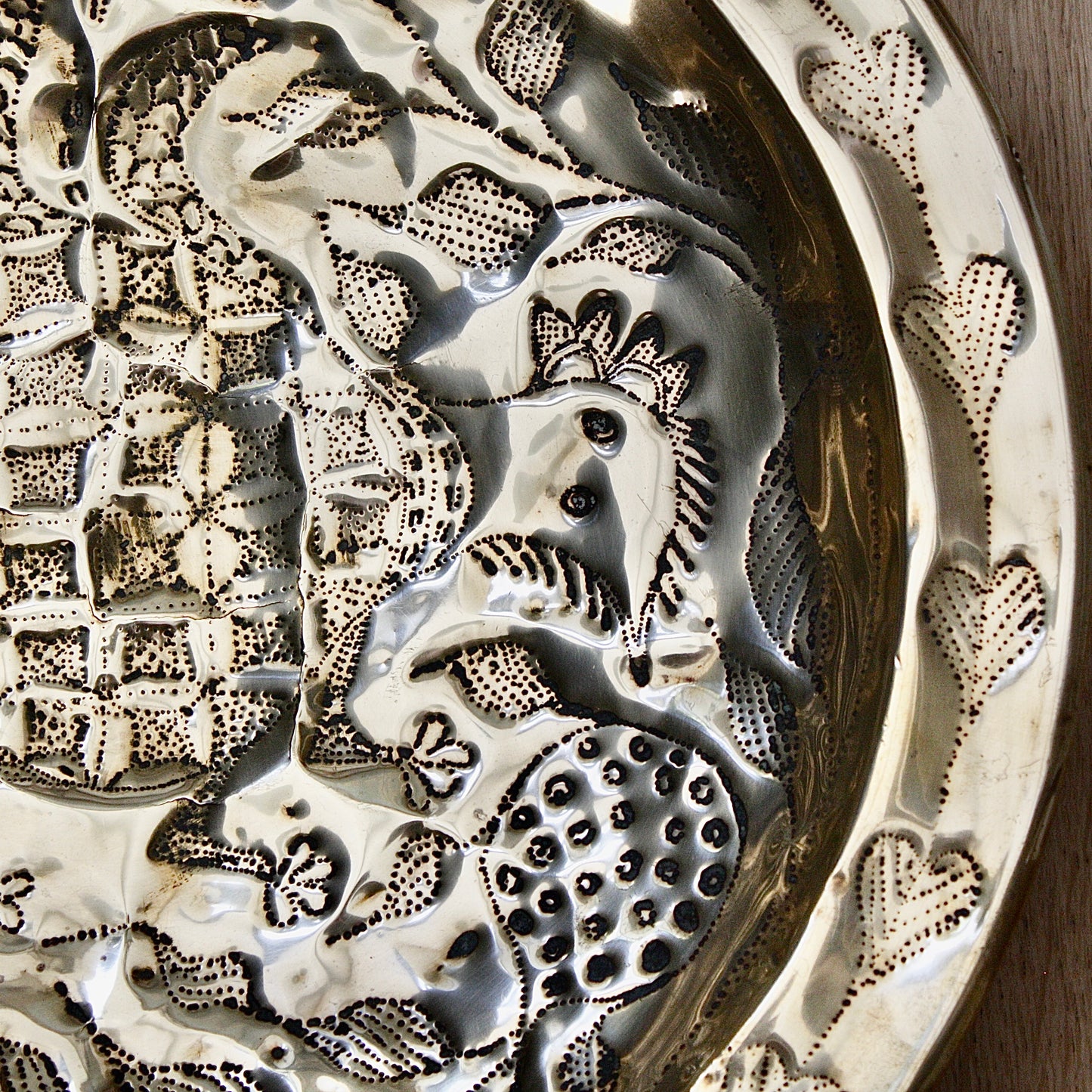 
                  
                    an embossed brass dish depicting " all of you " from old calabar.
                  
                