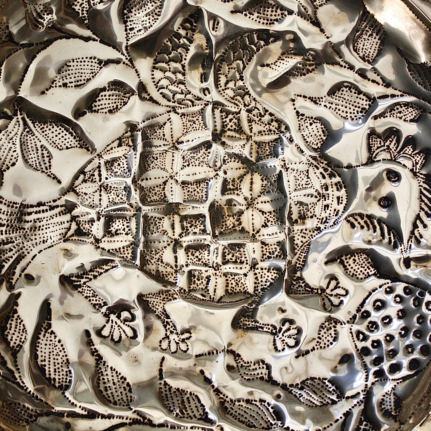 
                  
                    an embossed brass dish depicting " all of you " from old calabar.
                  
                