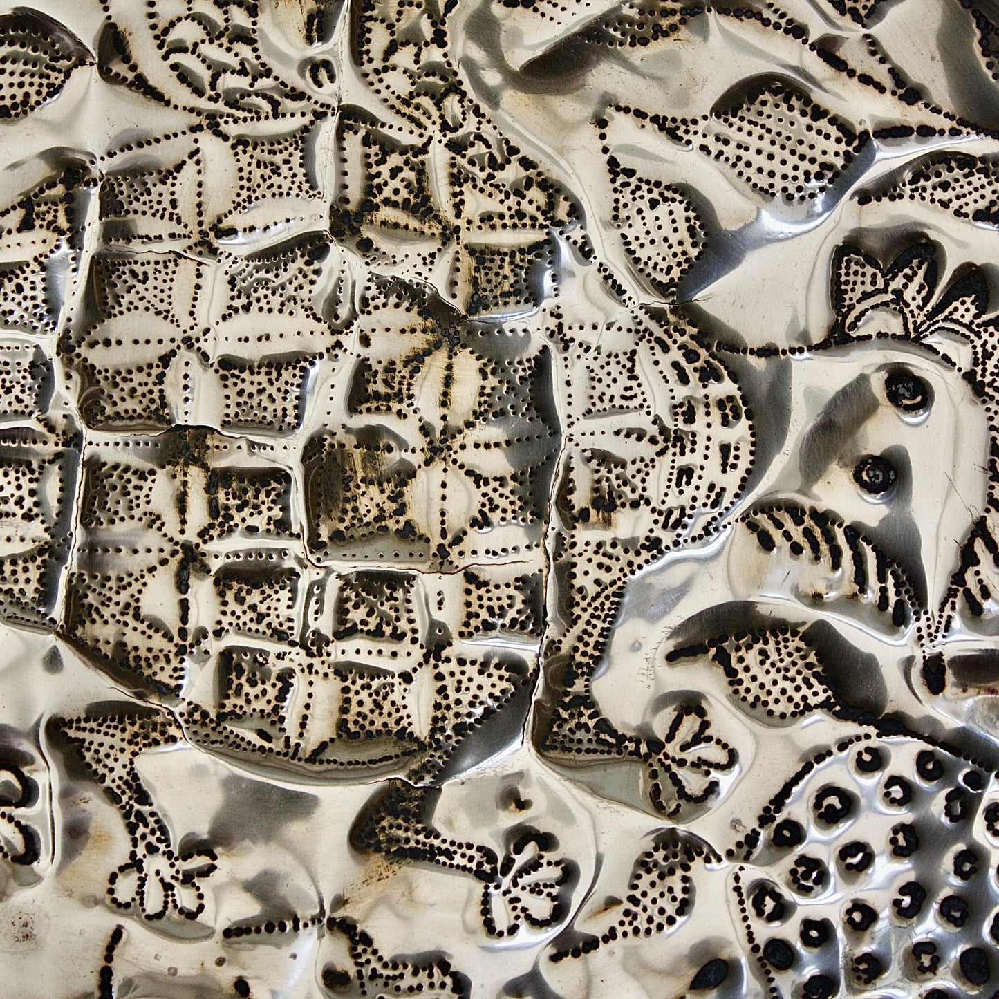 
                  
                    an embossed brass dish depicting " all of you " from old calabar.
                  
                