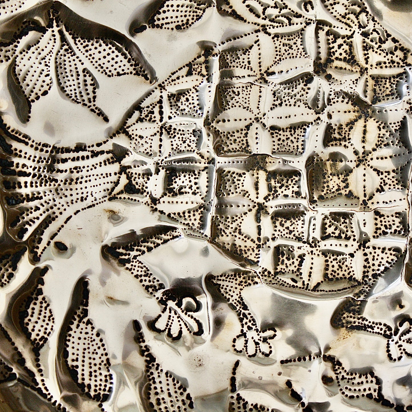 
                  
                    an embossed brass dish depicting " all of you " from old calabar.
                  
                