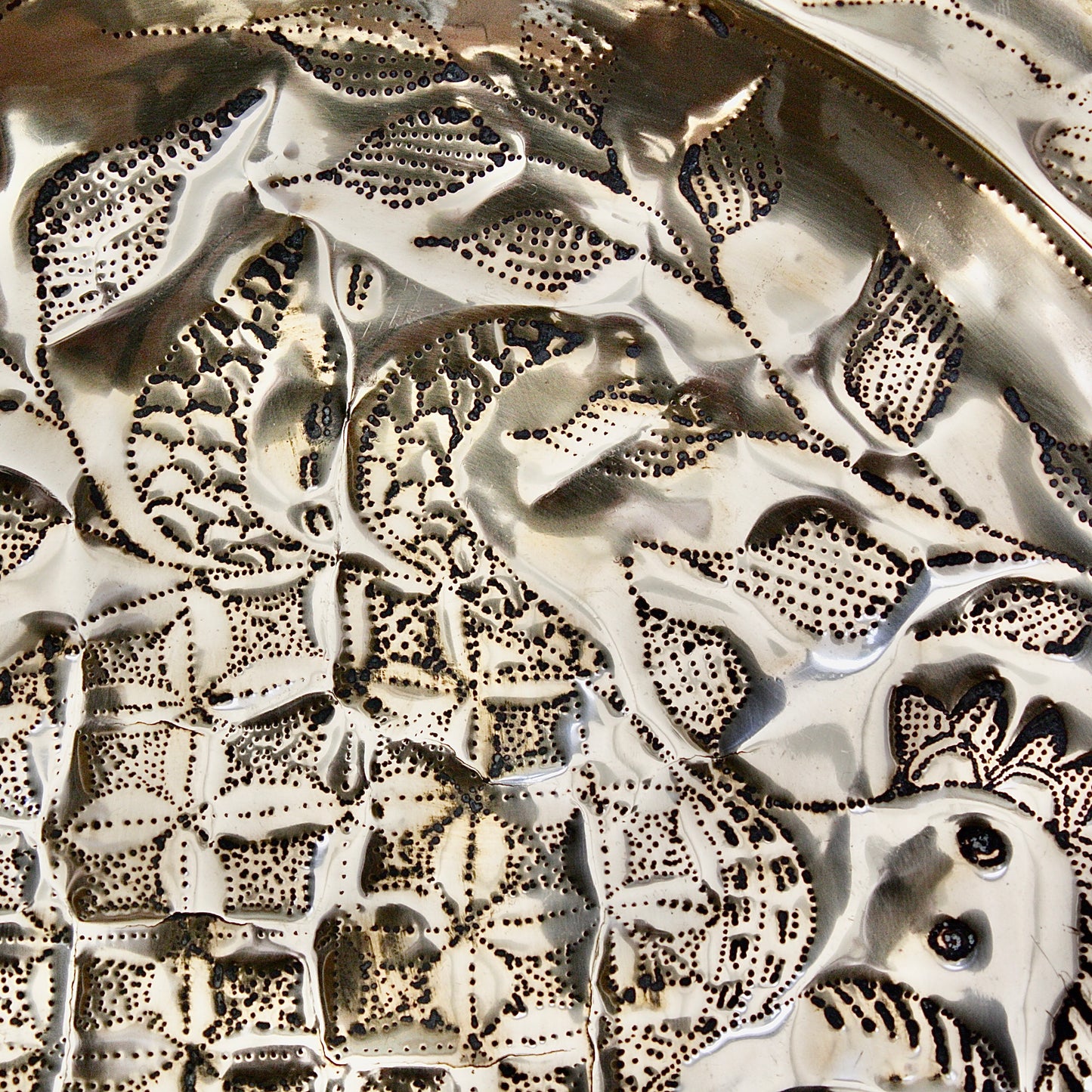 
                  
                    an embossed brass dish depicting " all of you " from old calabar.
                  
                