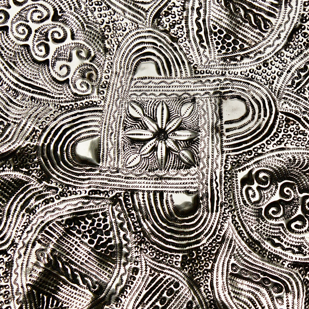 
                  
                    a nigerian embossed charger
                  
                