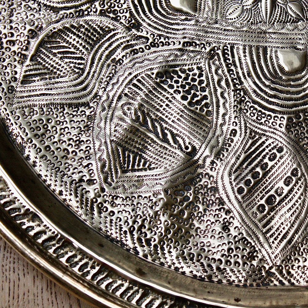
                  
                    a nigerian embossed charger
                  
                