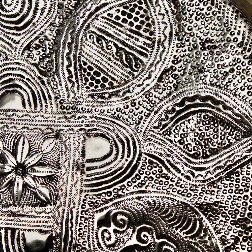 
                  
                    a nigerian embossed charger
                  
                