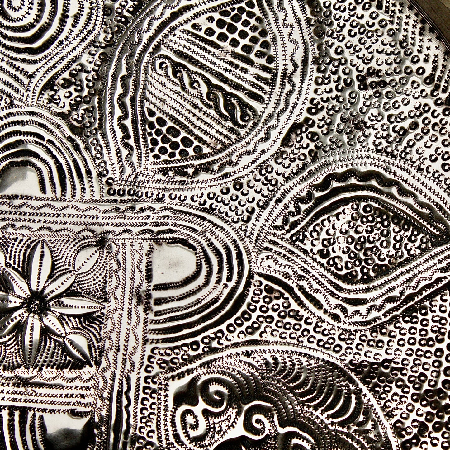 
                  
                    a nigerian embossed charger
                  
                