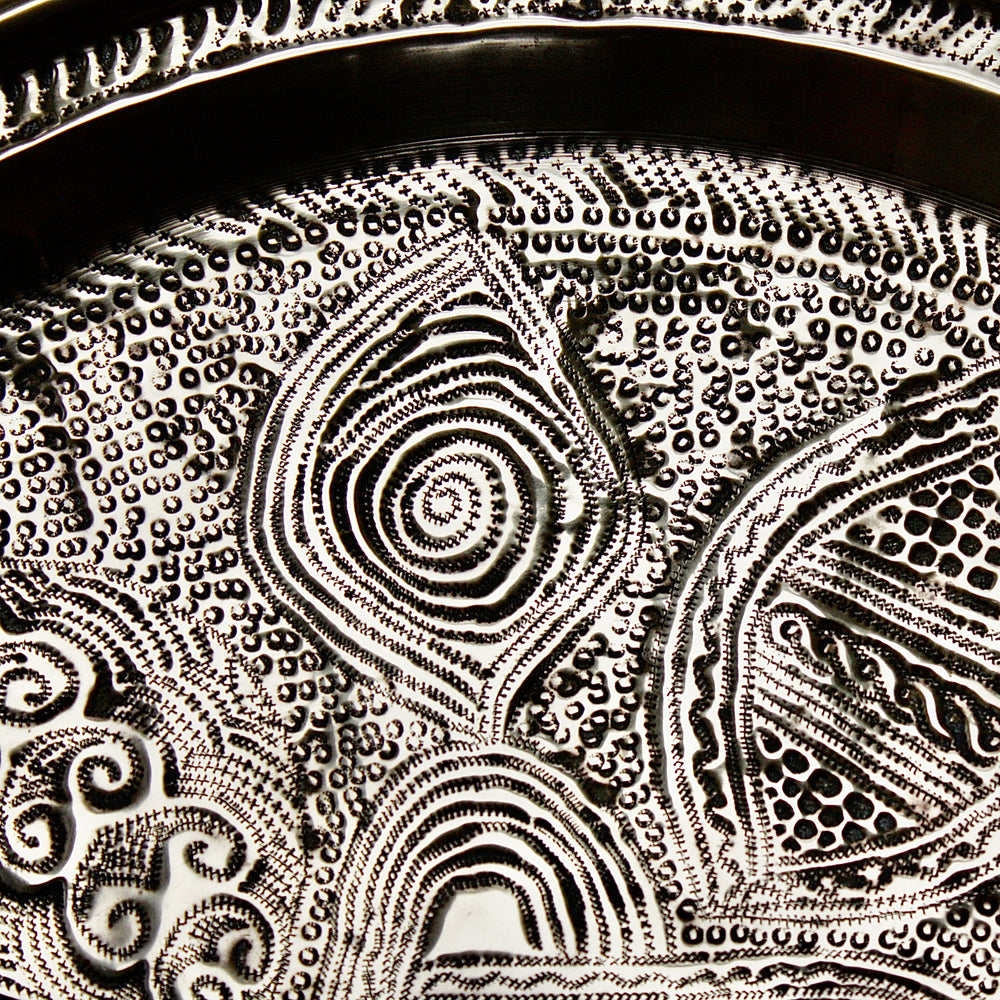 
                  
                    a nigerian embossed charger
                  
                
