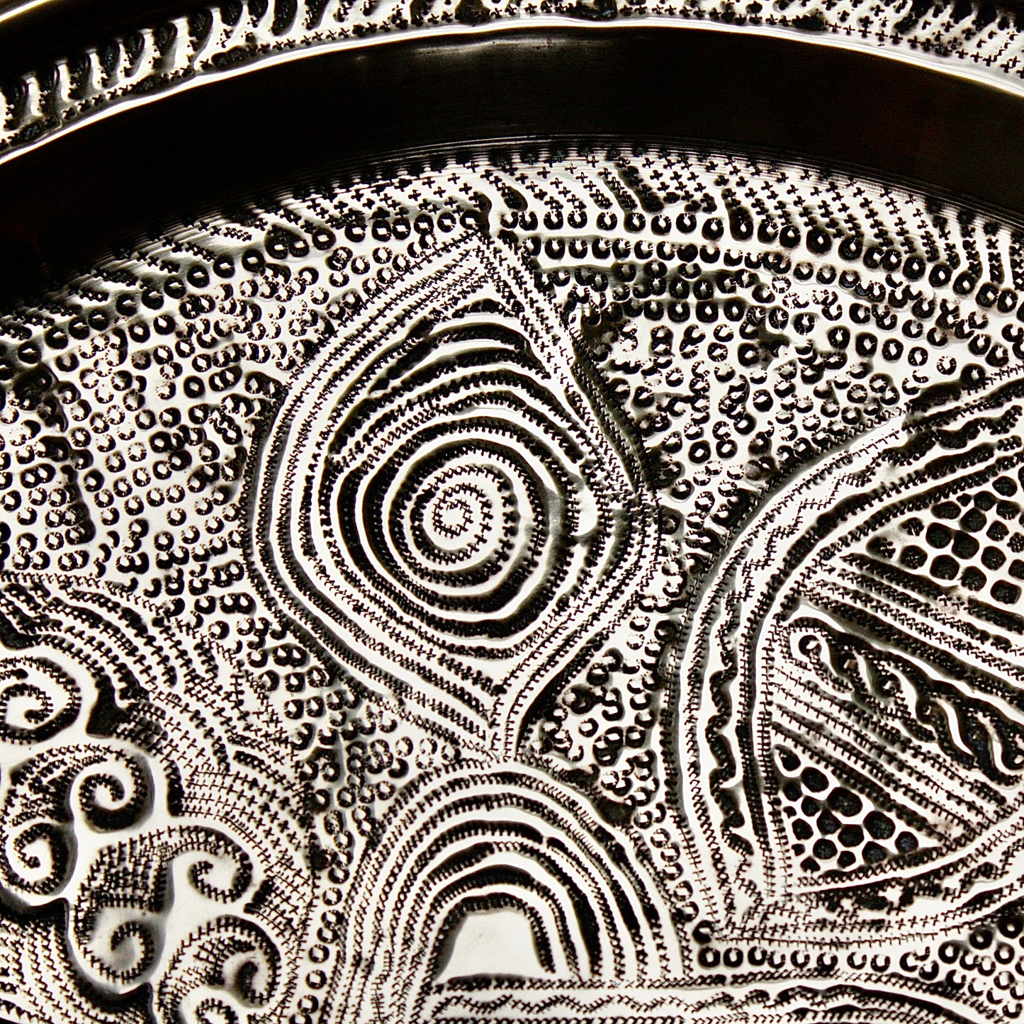 
                  
                    a nigerian embossed charger
                  
                