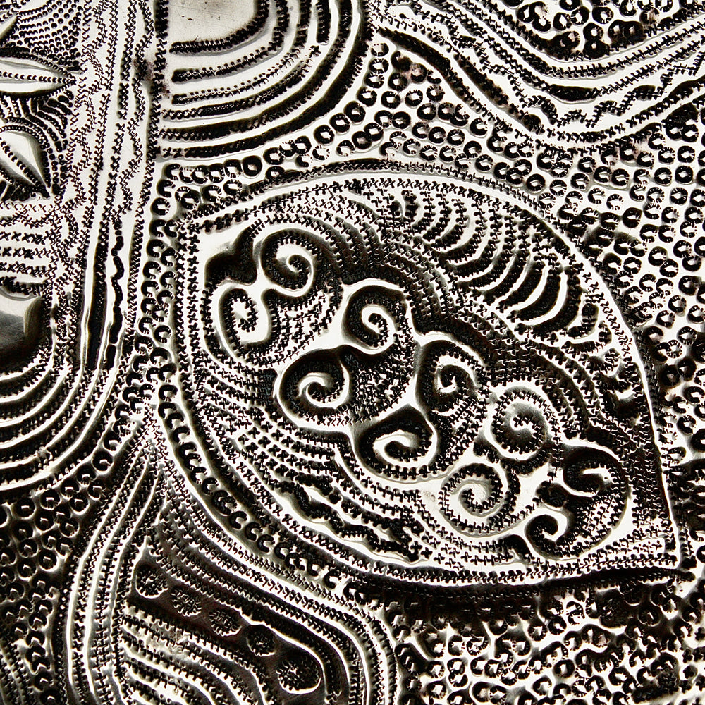 
                  
                    a nigerian embossed charger
                  
                
