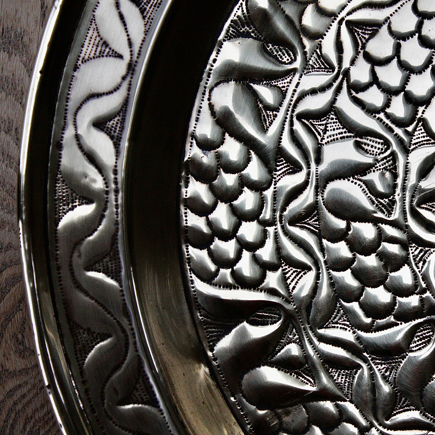 
                  
                    an embossed brass charger from old calabar with a radiating concentric pattern.
                  
                