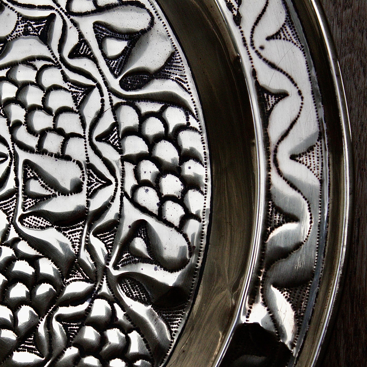 
                  
                    an embossed brass charger from old calabar with a radiating concentric pattern.
                  
                