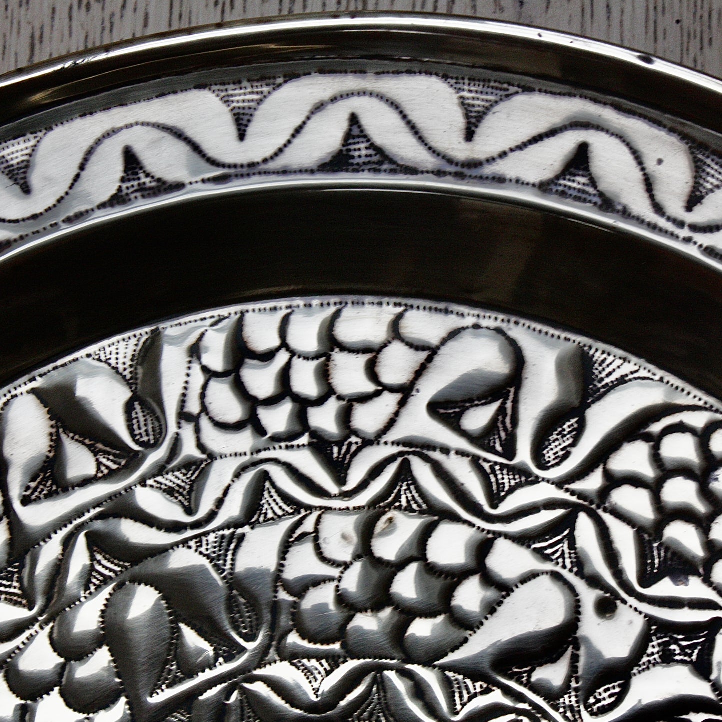 
                  
                    an embossed brass charger from old calabar with a radiating concentric pattern.
                  
                