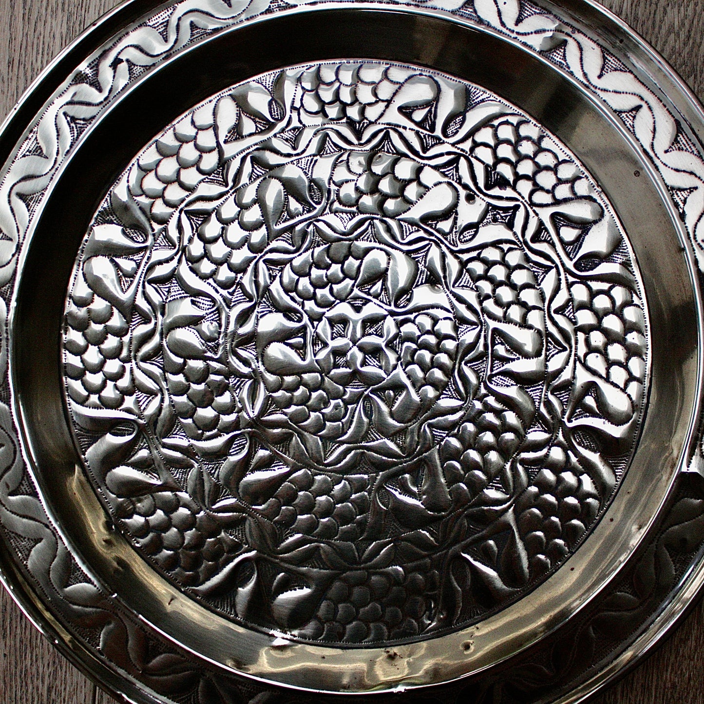
                  
                    an embossed brass charger from old calabar with a radiating concentric pattern.
                  
                