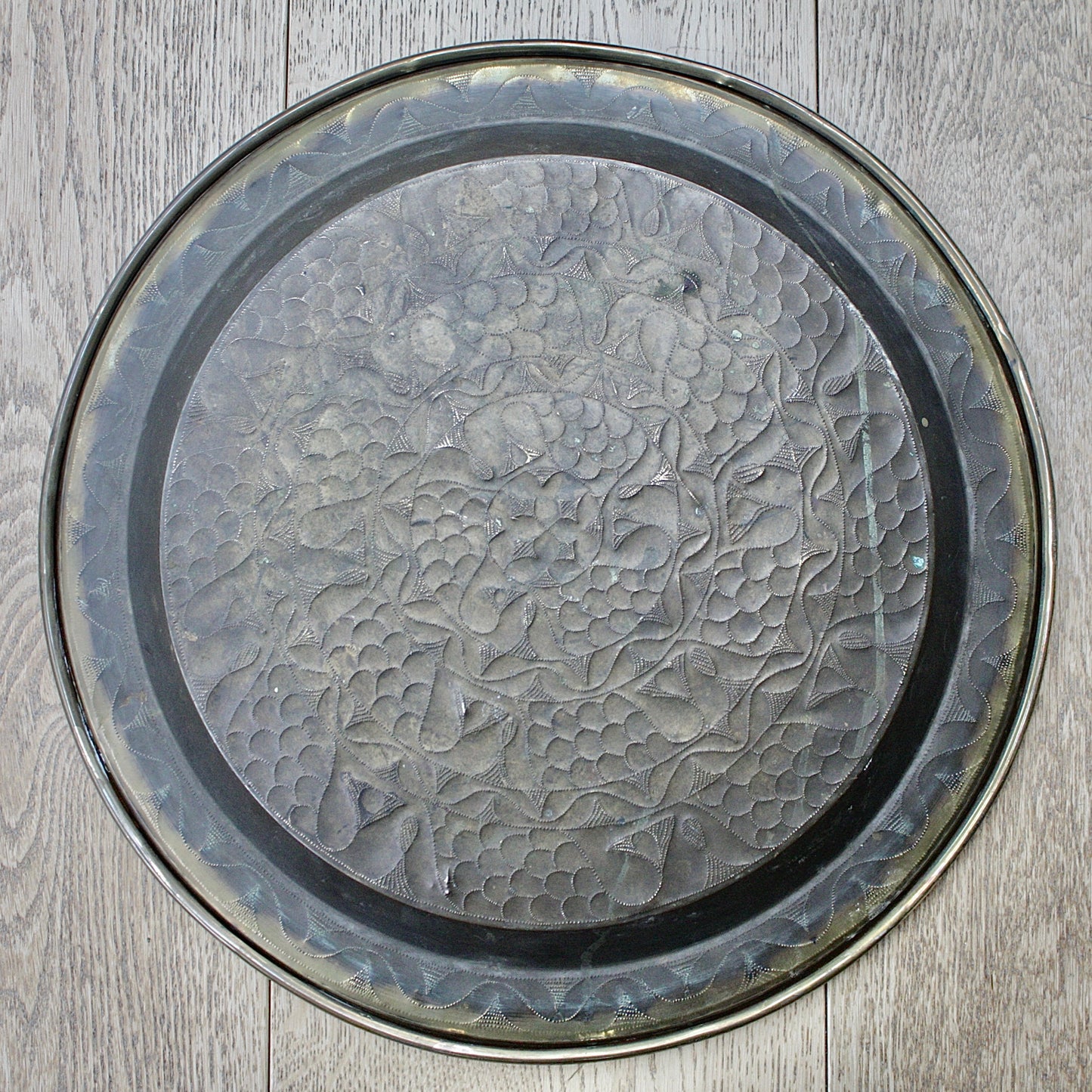 
                  
                    an embossed brass charger from old calabar with a radiating concentric pattern.
                  
                