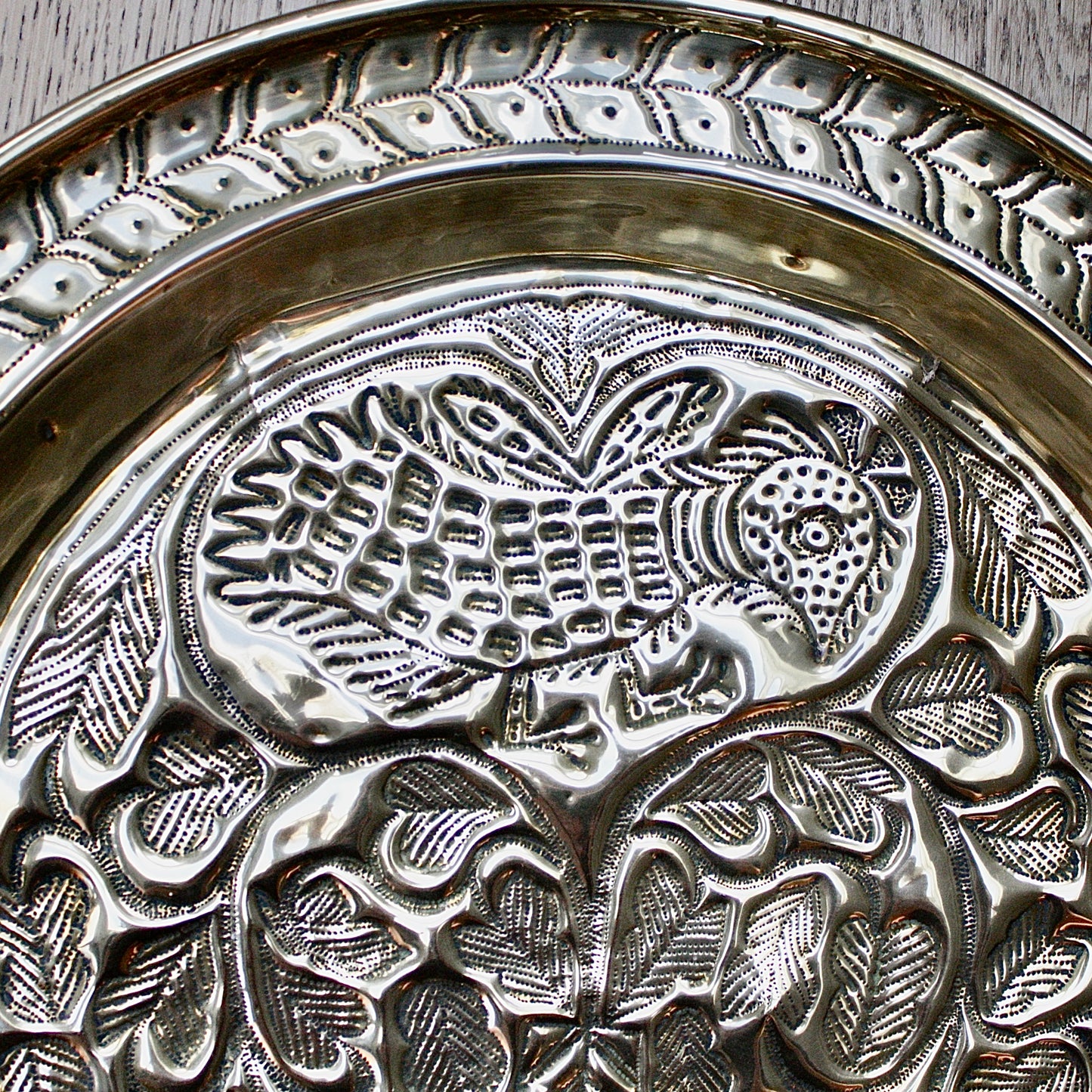 
                  
                    an old calabar charger decorated with a bird in a tree.
                  
                