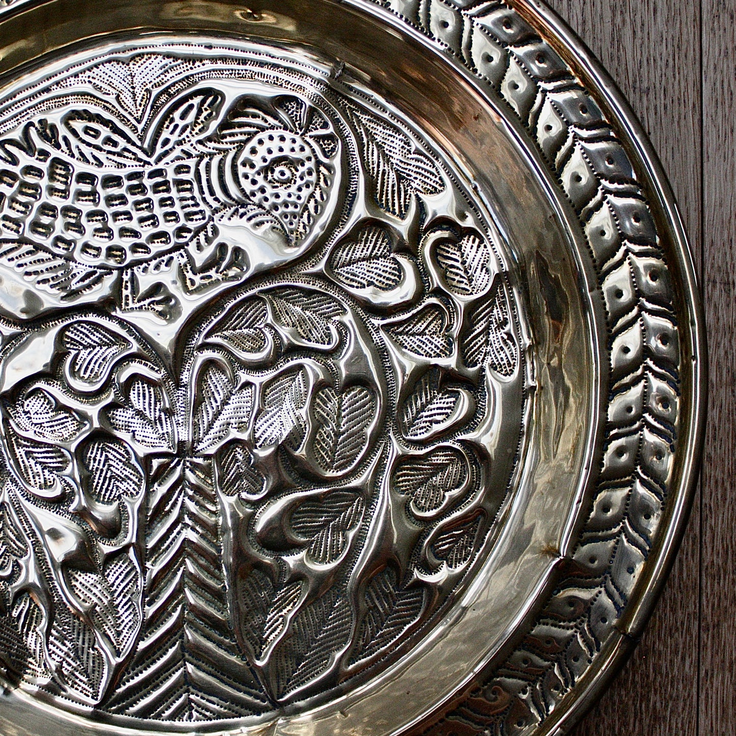 
                  
                    an old calabar charger decorated with a bird in a tree.
                  
                