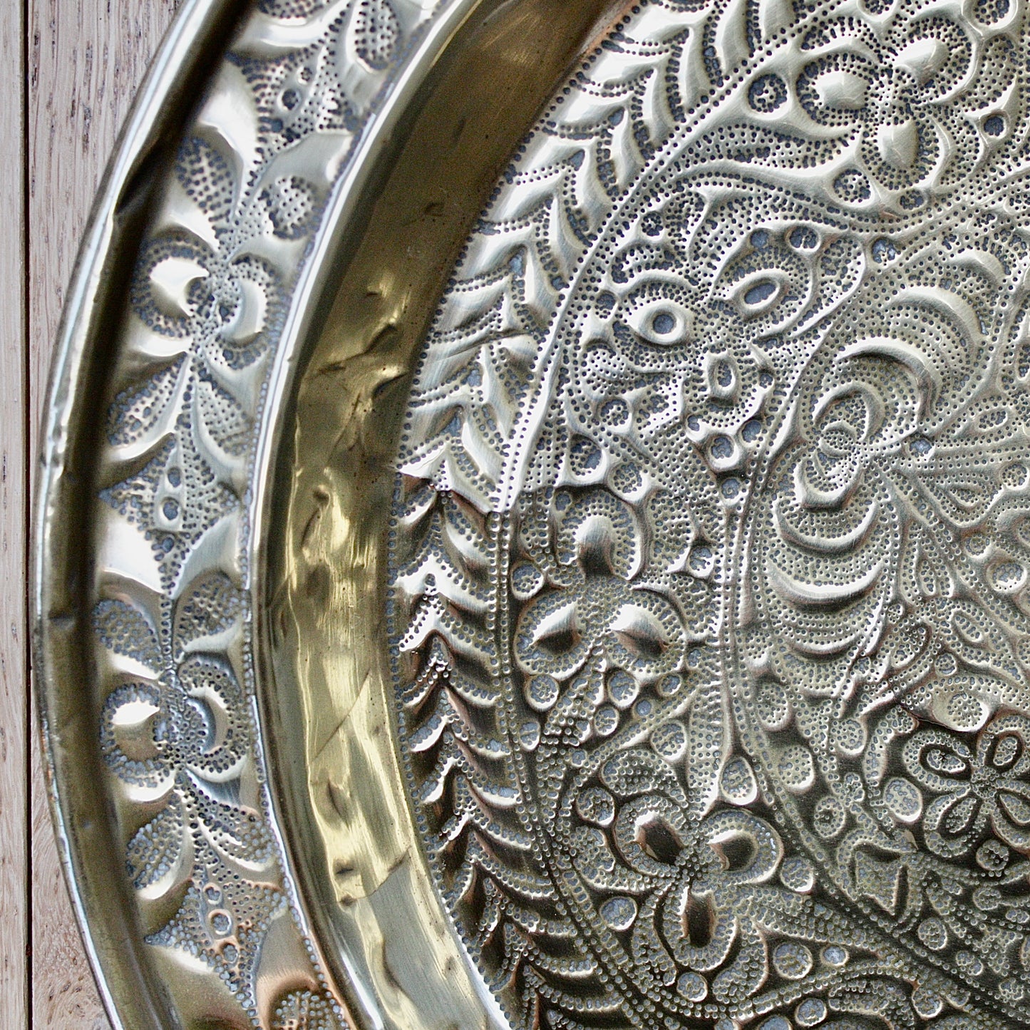 
                  
                    a detailed antique african efik embossed brass charger from old calabar.
                  
                