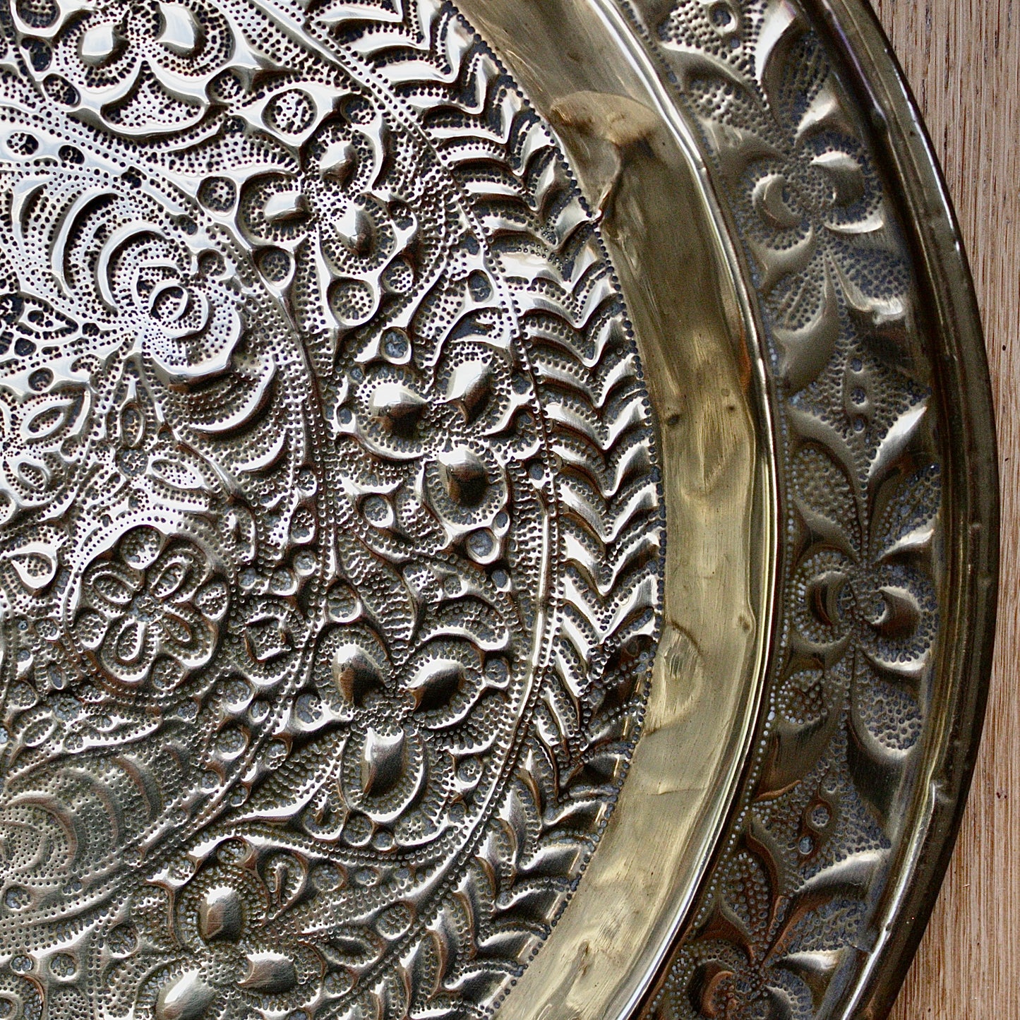 
                  
                    a detailed antique african efik embossed brass charger from old calabar.
                  
                