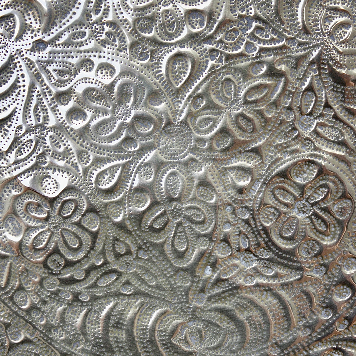 
                  
                    a detailed antique african efik embossed brass charger from old calabar.
                  
                