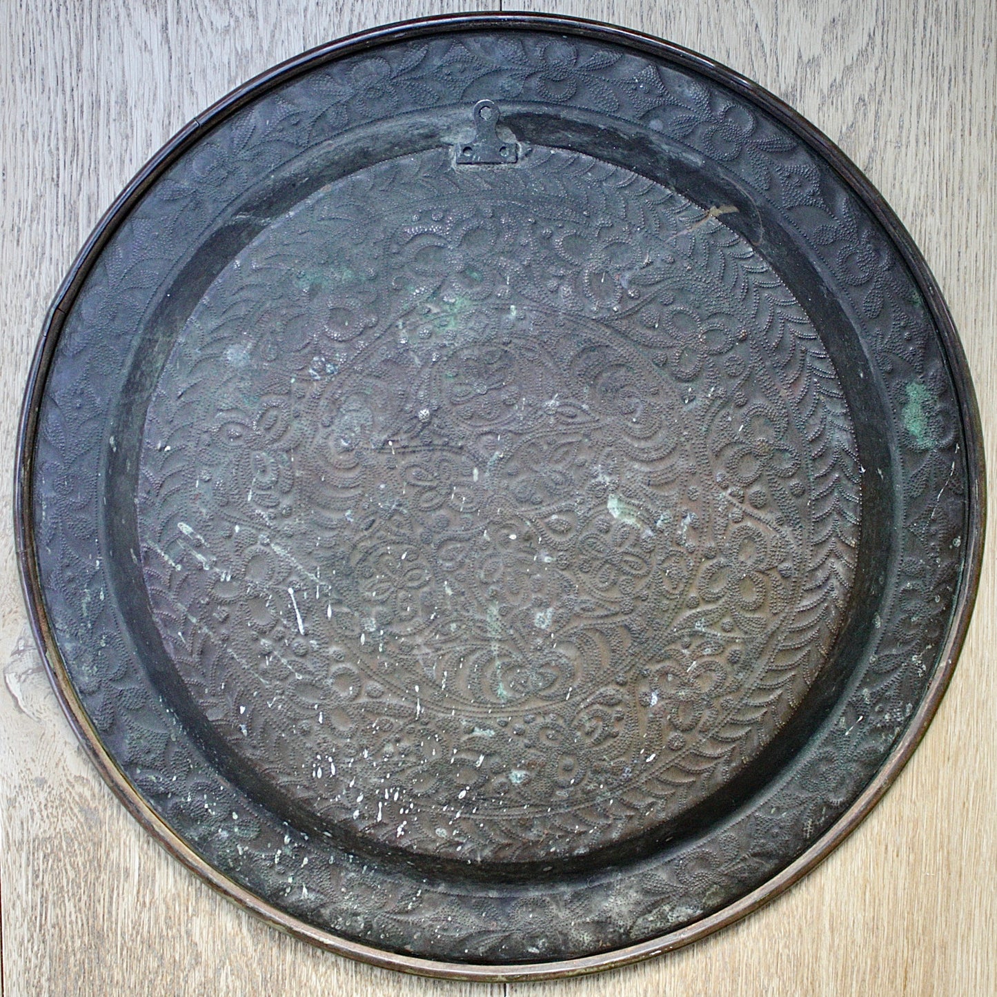 
                  
                    a detailed antique african efik embossed brass charger from old calabar.
                  
                