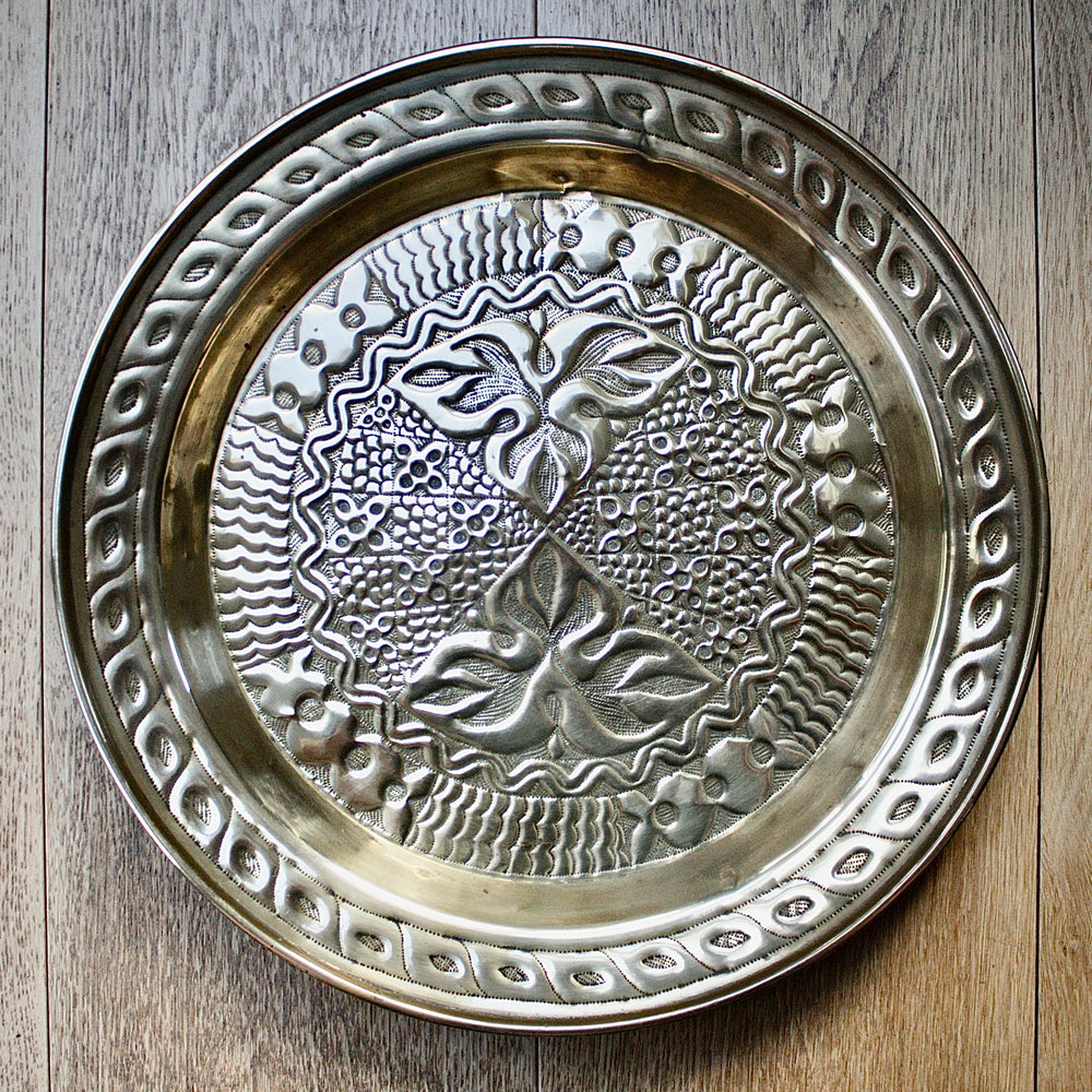 an intricately designed embossed charger from old calabar.