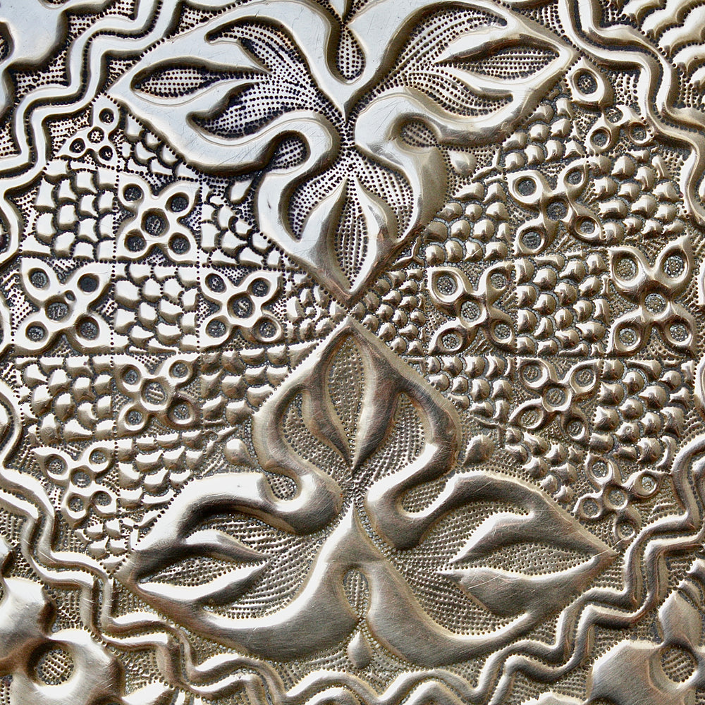
                  
                    an intricately designed embossed charger from old calabar.
                  
                