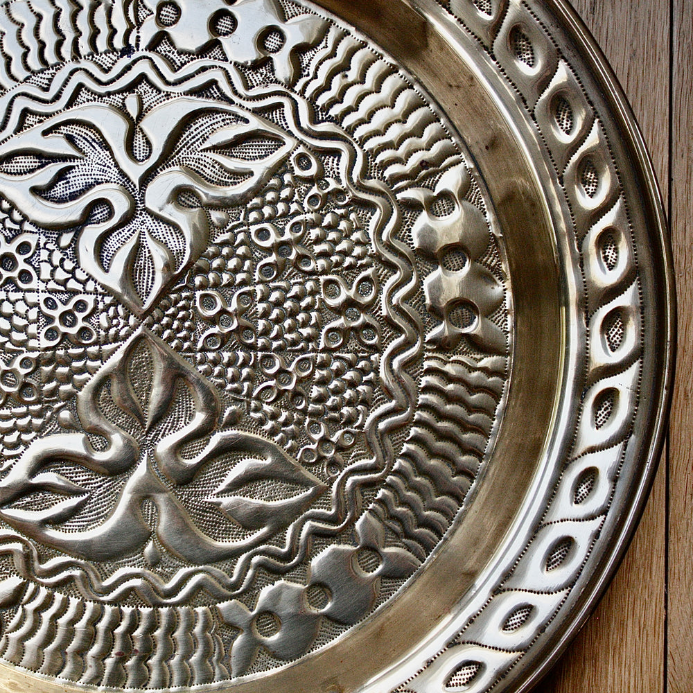 
                  
                    an intricately designed embossed charger from old calabar.
                  
                