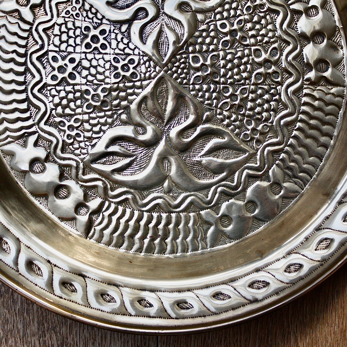 
                  
                    an intricately designed embossed charger from old calabar.
                  
                