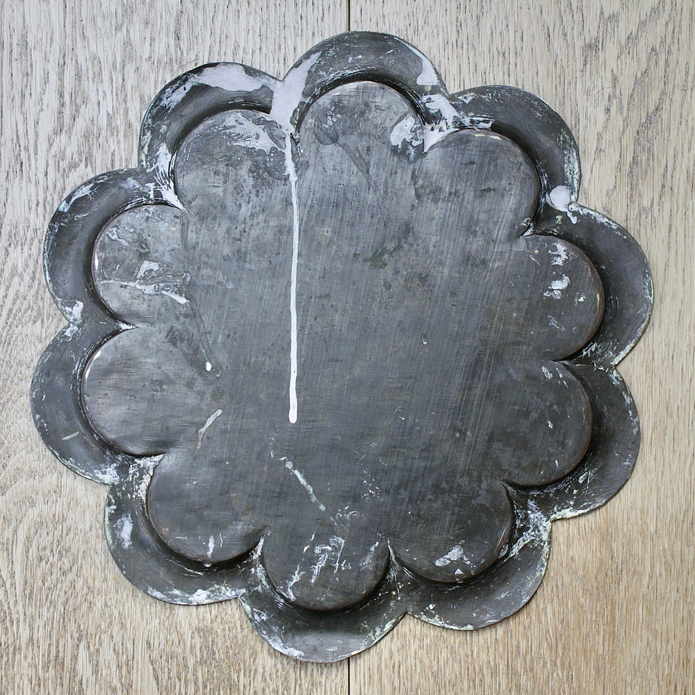 
                  
                    an antique Indian engraved brass thali.
                  
                