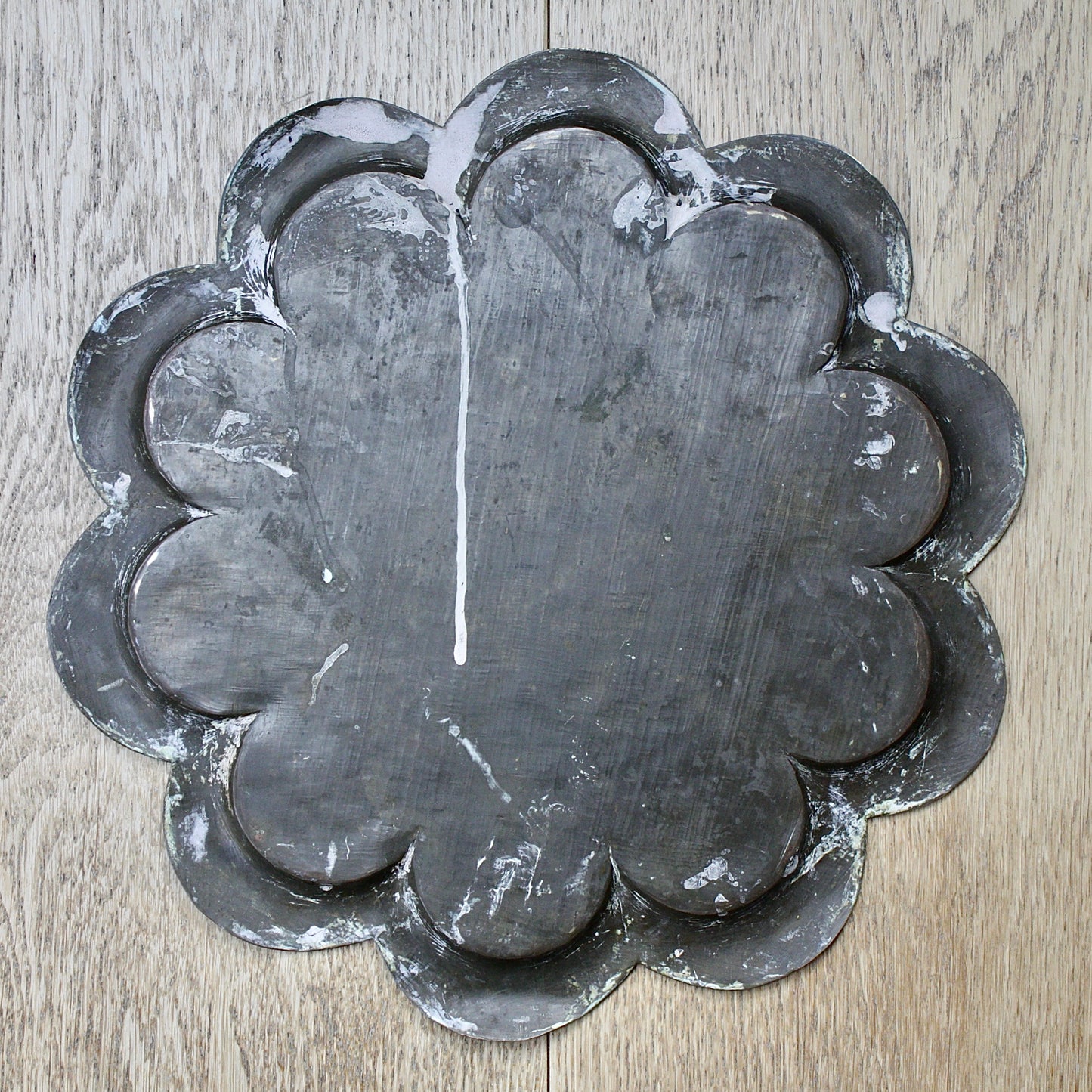 
                  
                    an antique Indian engraved brass thali.
                  
                