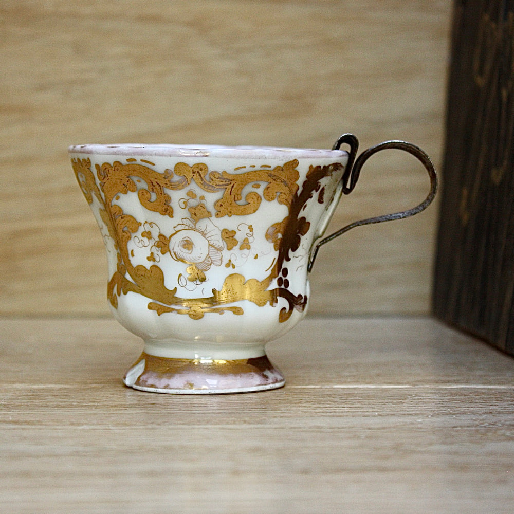 
                  
                    a cup by kpm with folk art appeal.
                  
                